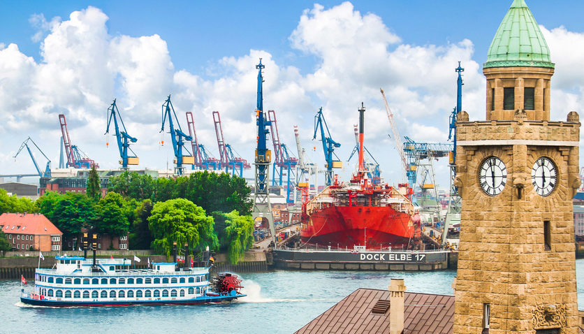 Famous Hamburger Landungsbruecken with harbor and traditional paddle steamer on Elbe river, St. Pauli district, Hamburg, Germany