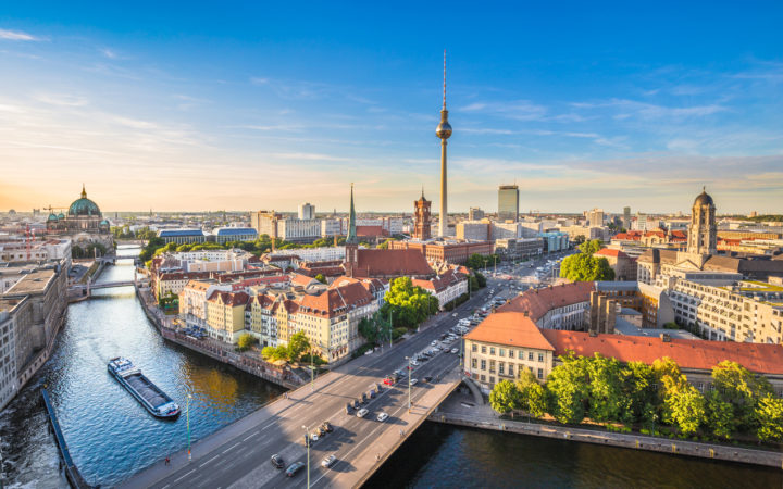 Aerial view of Berlin skyline with famous TV tower and Spree river in beautiful evening light at sunset, Germany.