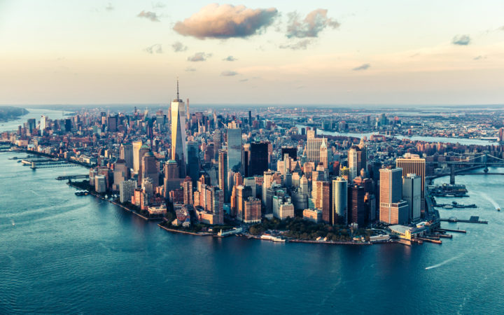 Image of the Manhattan skyline at sunset from an elevated angle.