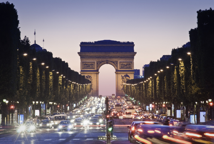 Pretty night time illuminations of the Impressive Arc de Triomphe (1833) along the famous tree lined Avenue des Champs-Elysees in Paris. ProPhoto profile for precise color reproduction.