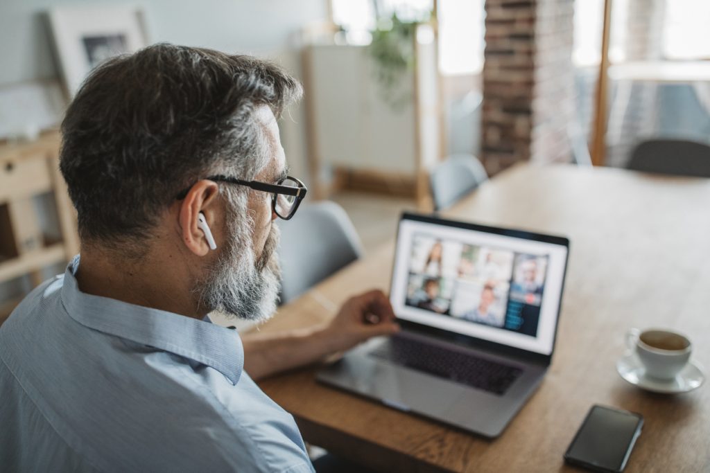 Mature men at home during pandemic isolation have conference  call