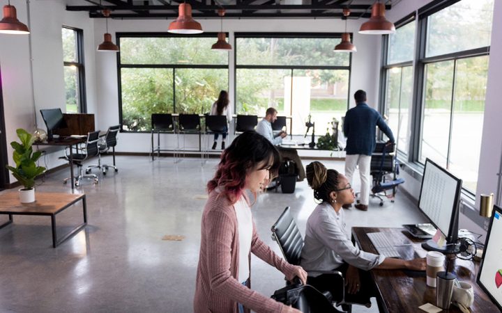 Diverse mid adult people share co-working space Several mid adult people share a co-working space to do freelance work or finish projects.