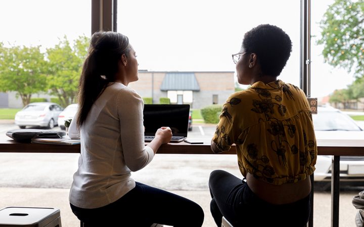 Female friends or business colleagues meet in coffee shop before or after work.