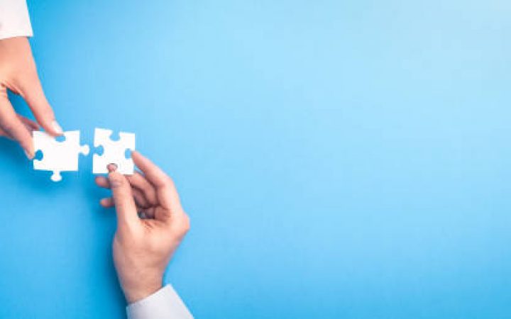 istockphoto-1208673733-612x612 The man and woman holds in hand a jigsaw puzzle. Business solutions, success and strategy concept.