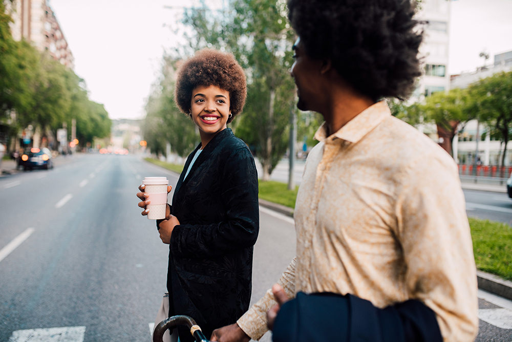 Young African - American couple go to work together.