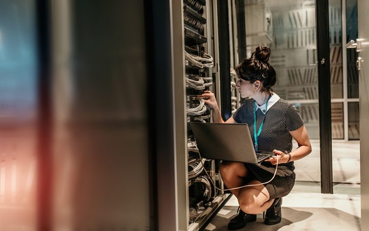 Female IT Engineer Working in Server Room