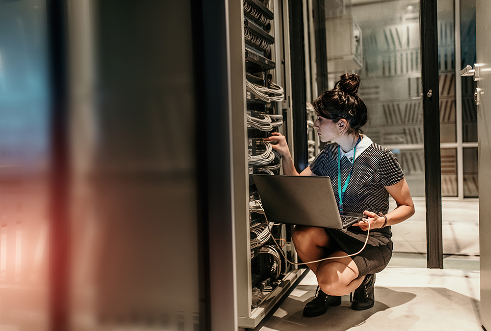 Female IT Engineer Working in Server Room