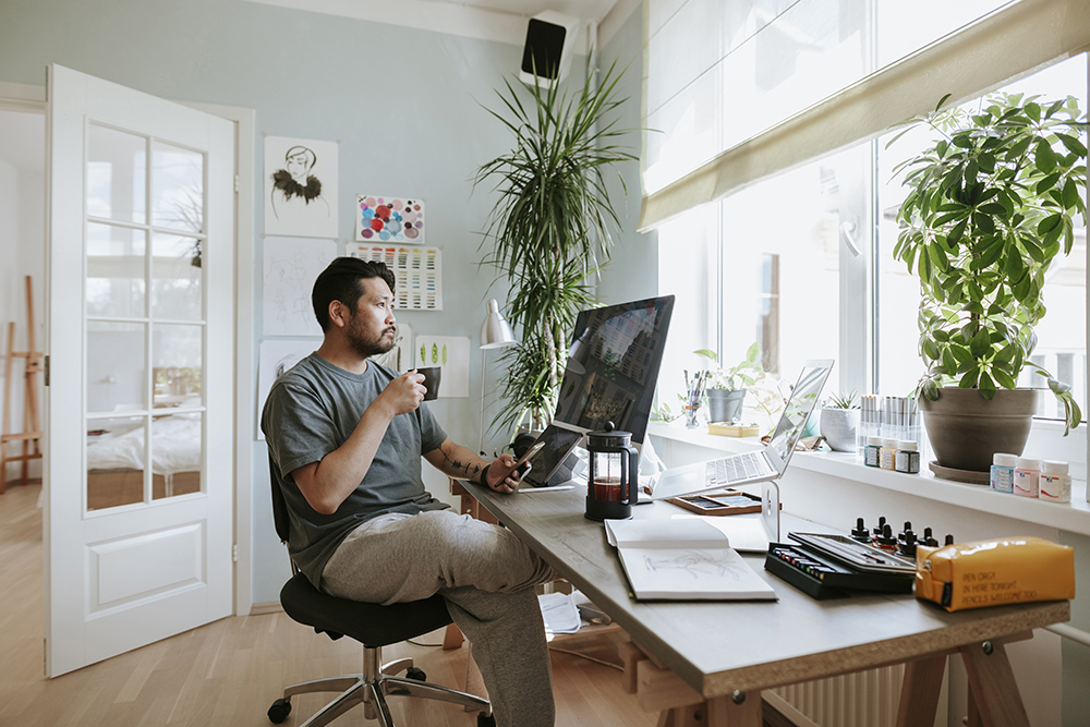 Photo series of Japanese digital artist at his home studio taking a coffee break.