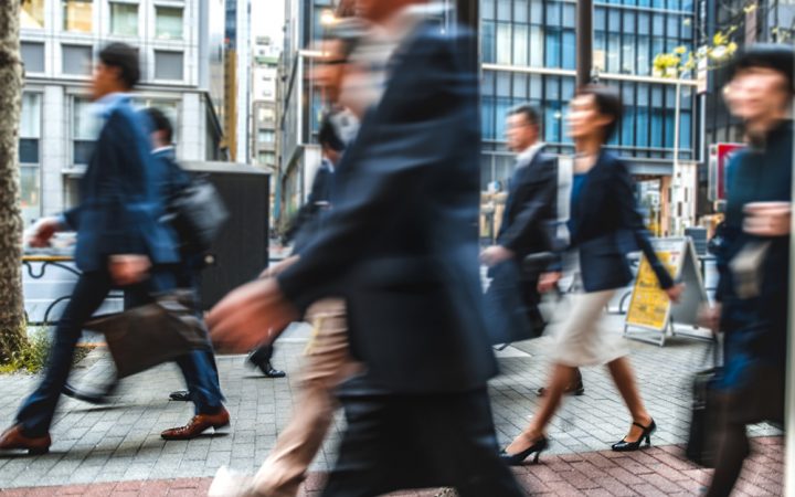 Blurred group of business people commuting on the streets of Japan