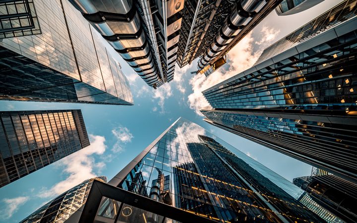 Highly detailed abstract wide angle view up towards the sky in the financial district of London City and its ultra modern contemporary buildings with unique architecture. Shot on Canon EOS R full frame with 10mm wide angle lens. Image is ideal for background.