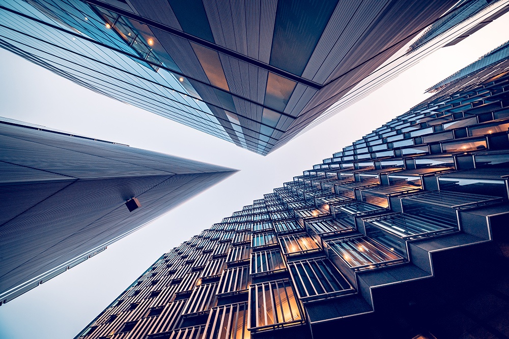 Looking directly up at the skyline of the financial district in central London - stock image Highly detailed abstract wide angle view up towards the sky in the financial district of London City and its ultra modern contemporary buildings with unique architecture. Shot on Canon EOS R full frame with 10mm wide angle lens. Image is ideal for background. Toned image.