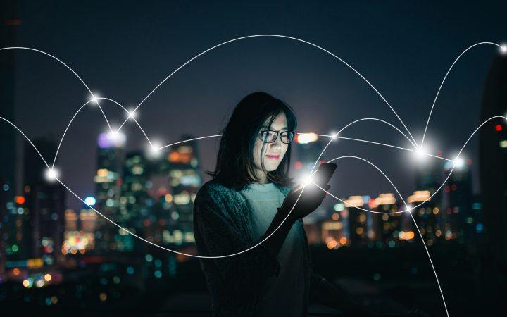 woman in the city using a tablet showing digital connection