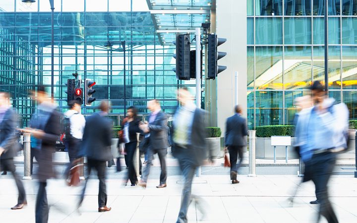 City workers walking quickly in a busy financial district