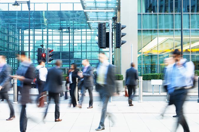 City workers walking quickly in a busy financial district