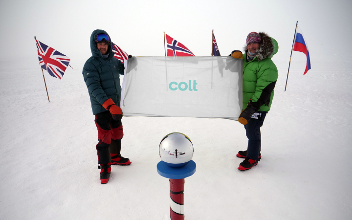 Robert Swan and son Barney raising the Colt flag at the South Pole