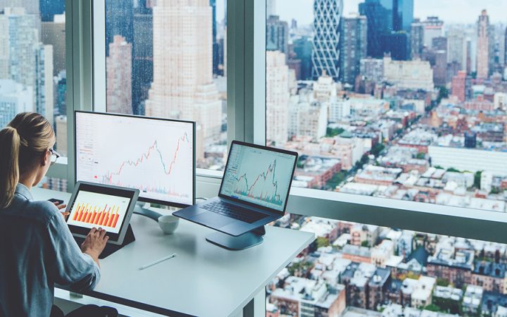 a person sat in an office overlooking a busy city landscape.