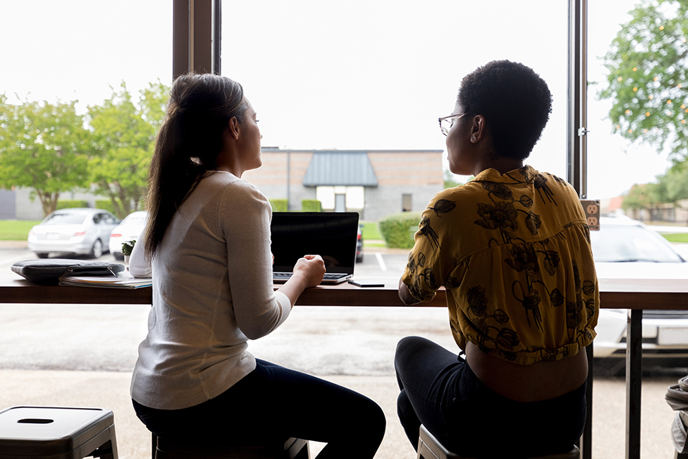 Female friends or business colleagues meet in coffee shop before or after work.