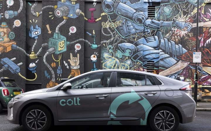 A Colt-branded electric car, in front of a Colt data centre