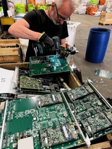 Man working on equipment during the metal recycling pilot with Colt and Urban Miners