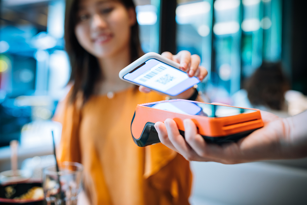 Asian young woman paying with smartphone in a cafe. Mobile Payment, Women, Contactless Payment,China - East Asia, Shanghai, 20-29 Years, Paying, Banking