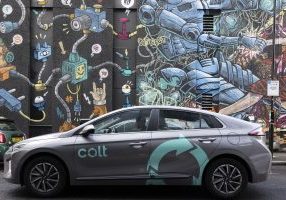 A Colt-branded electric car, in front of a Colt data centre