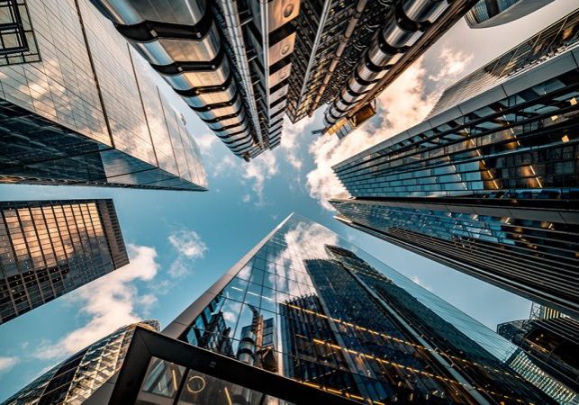 Highly detailed abstract wide angle view up towards the sky in the financial district of London City and its ultra modern contemporary buildings with unique architecture. Shot on Canon EOS R full frame with 10mm wide angle lens. Image is ideal for background.