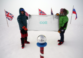 Robert Swan and son Barney raising the Colt flag at the South Pole